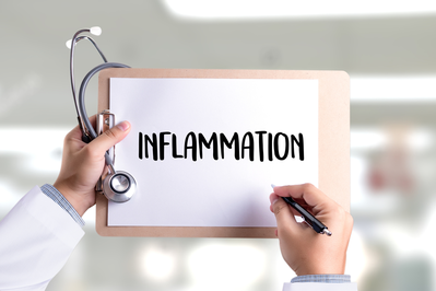 doctor writing inflammation on a paper