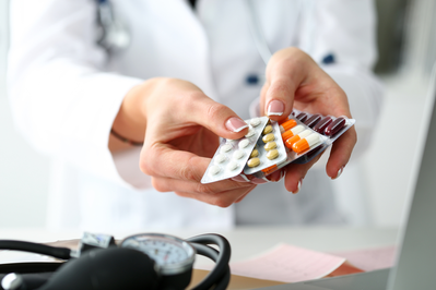 doctor holding packs of medication