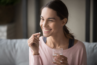 happy woman taking pill