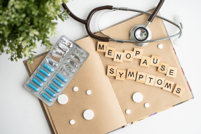 menopause symptoms in book with stethoscope