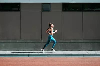 woman jogging on sidewalk