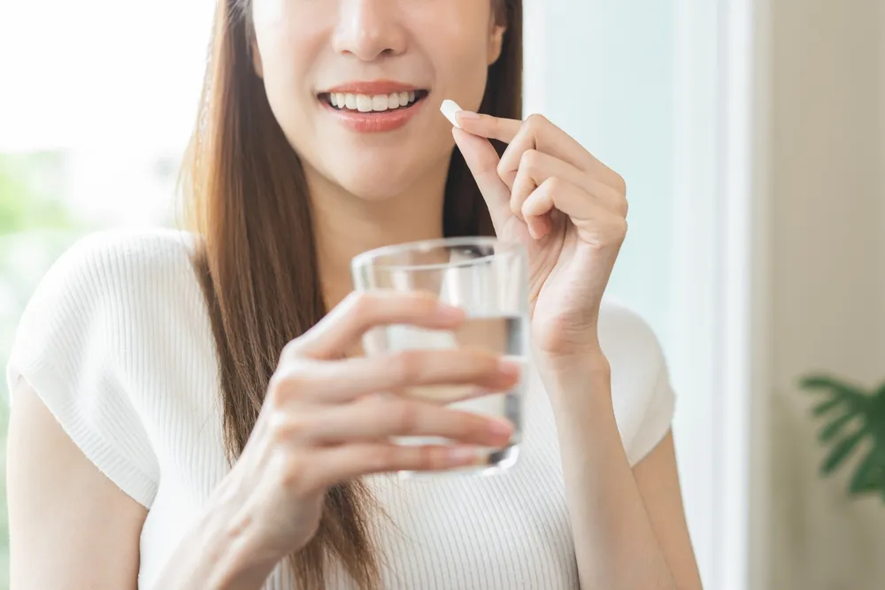 woman taking supplement
