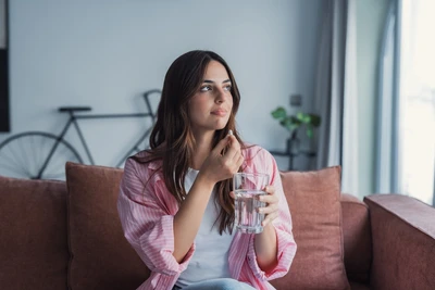 woman taking supplement